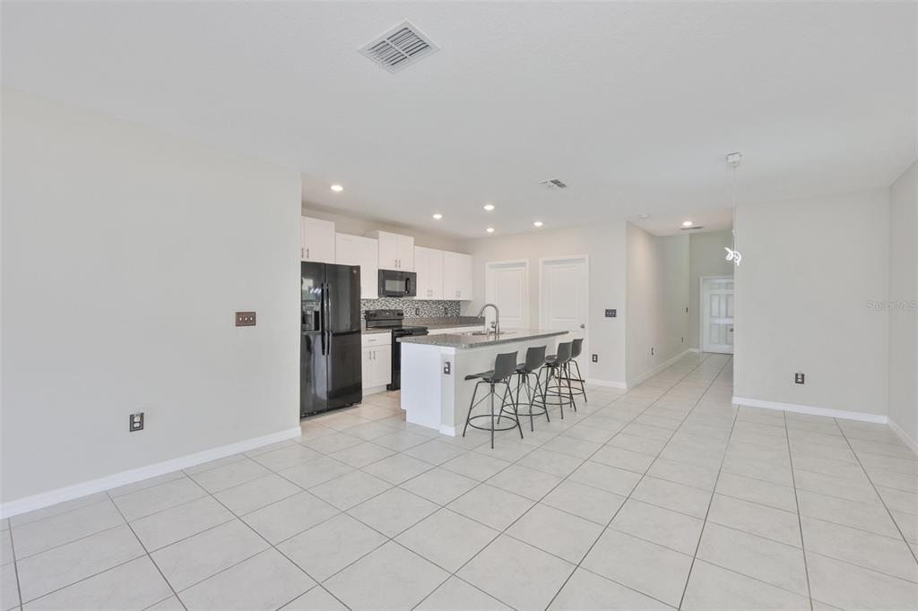 797 Olive Conch Street Ruskin, FL 33570 - Photo 3 of 53 a kitchen with a refrigerator and a table