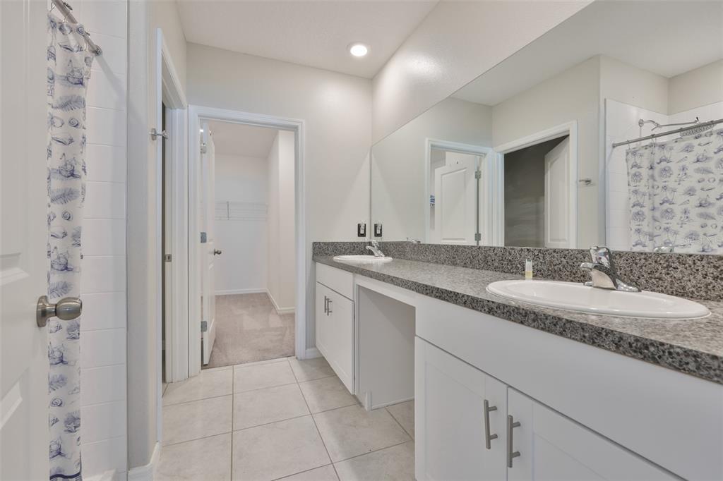 797 Olive Conch Street Ruskin, FL 33570 - Photo 31 of 53 a bathroom with a granite countertop sink and a mirror