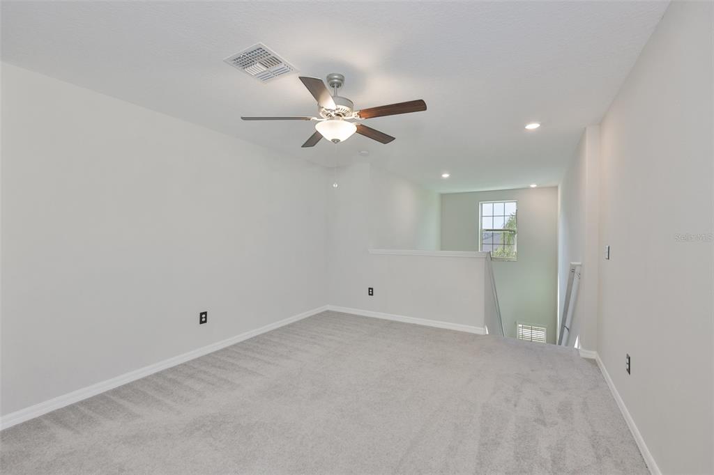 797 Olive Conch Street Ruskin, FL 33570 - Photo 36 of 53 an empty room with fan and a ceiling fan