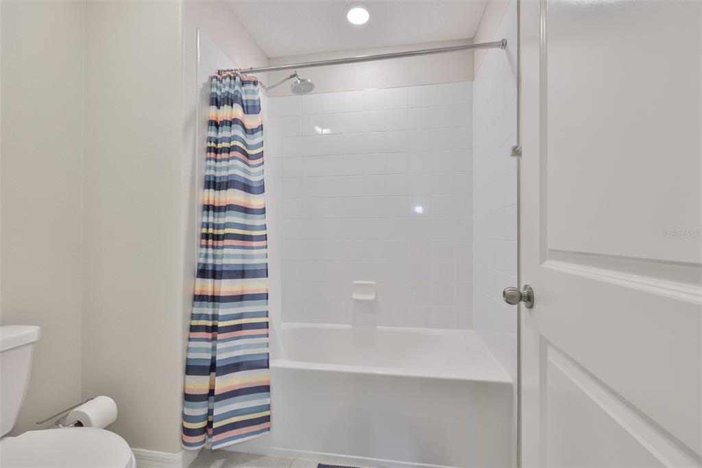 797 Olive Conch Street Ruskin, FL 33570 - Photo 37 of 53 a bathroom with a shower and a toilet