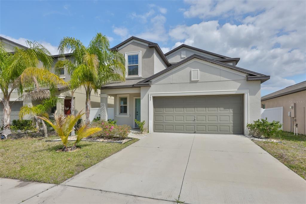 797 Olive Conch Street Ruskin, FL 33570 - Photo 42 of 53 a front view of a house with a yard and garage