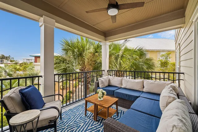 a balcony with furniture and a large window