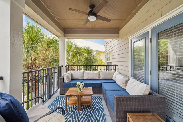 a living room with large windows a table and chairs