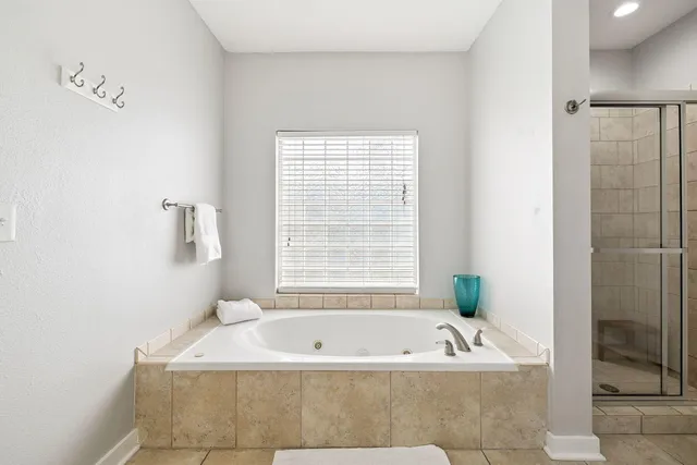 a bath tub sitting next to a window