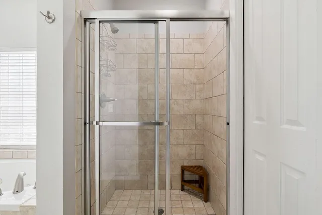 a bathroom with a glass shower door
