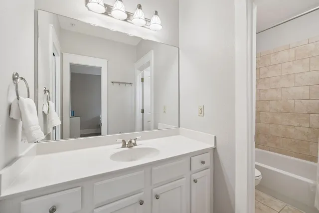 a bathroom with a sink vanity granite shower and a mirror