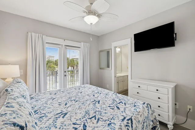 a bedroom with a bed tv and a window