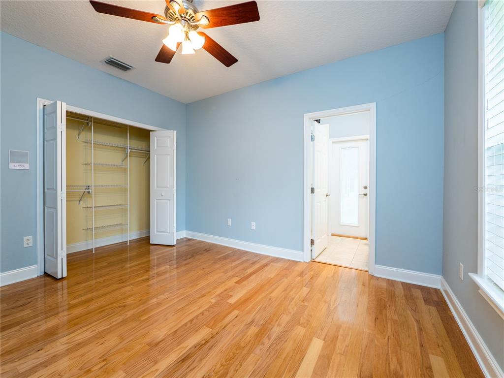 1945 Southwest 40th Place Ocala, FL 34471 - Photo 19 of 31 an empty room with wooden floor closet and windows