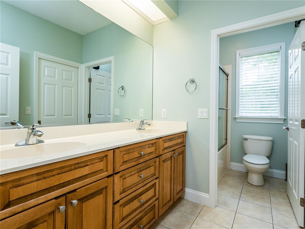 1945 Southwest 40th Place Ocala, FL 34471 - Photo 23 of 31 a bathroom with a sink a toilet and a mirror
