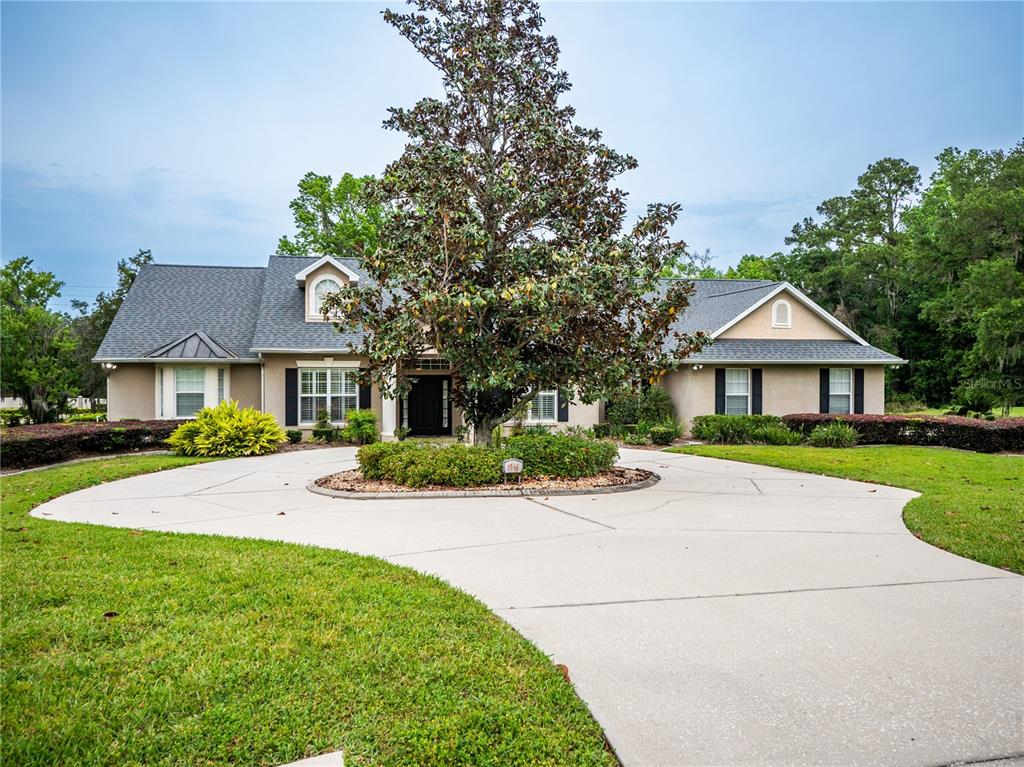 1945 Southwest 40th Place Ocala, FL 34471 - Photo 29 of 31 a front view of a house with a yard and garage
