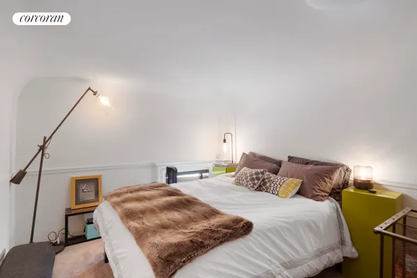 a bedroom with a bed and a couch