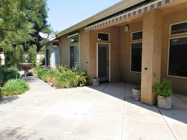 a view of a house with potted plants
