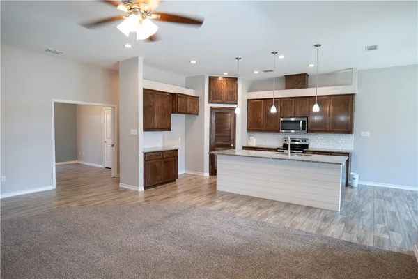 a view of kitchen with microwave and refrigerator