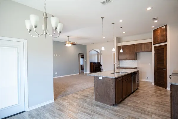 a open kitchen with stainless steel appliances granite countertop a stove and refrigerator