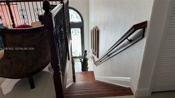 a view of entryway and hall with wooden floor