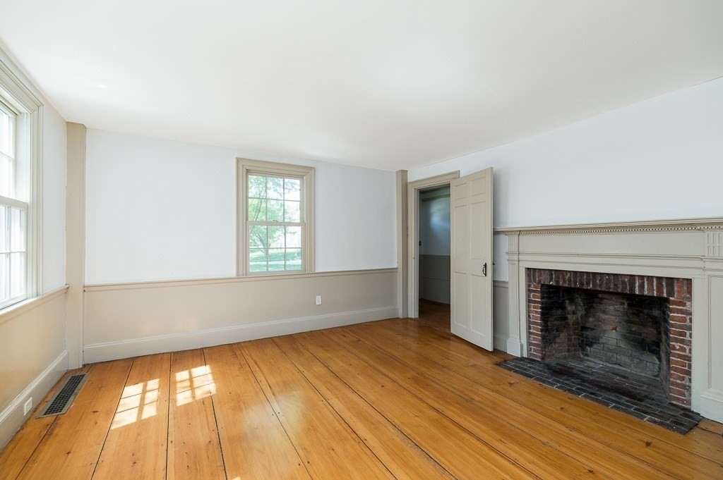 5 Middleton Road Boxford, MA 01921 - Photo 14 of 41 an empty room with wooden floor fireplace and windows
