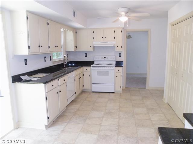 4703 Wilconna Road Chesterfield, VA 23832 - Photo 4 of 12 a kitchen with granite countertop a stove a sink and a refrigerator