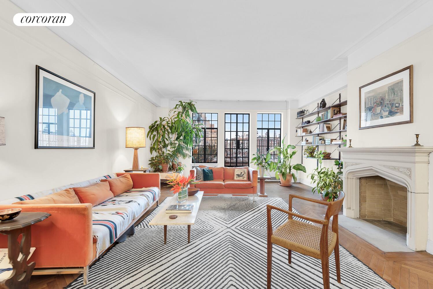 a living room with furniture a fireplace and a window
