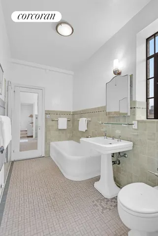 a bathroom with a sink a toilet and mirror