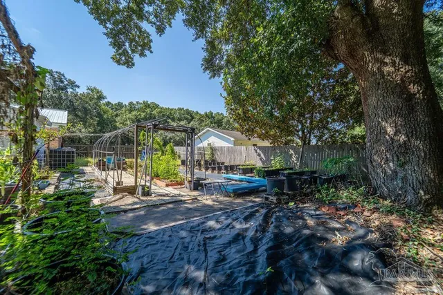 a view of a house with backyard water fountain and sitting area
