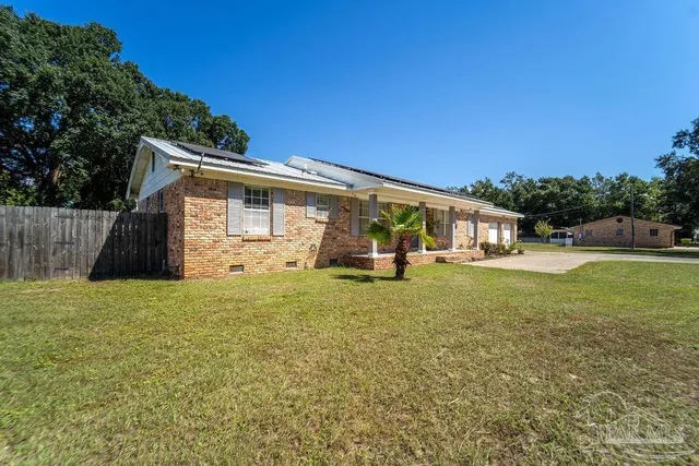 a aerial view of a residential apartment building with a yard
