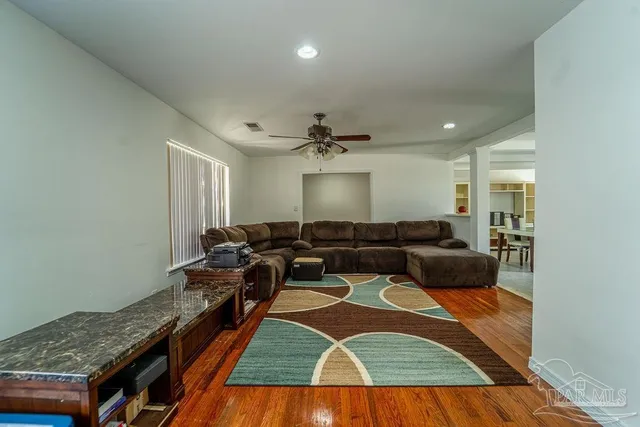 a view of a livingroom with furniture window and wooden floor