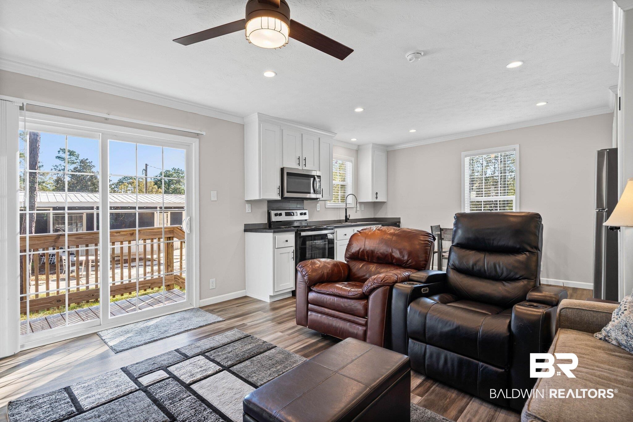 1325 Ridgewood Drive Lillian, AL 36549 - Photo 2 of 32 Living area with ornamental molding, dark wood finished floors, a ceiling fan, and recessed lighting