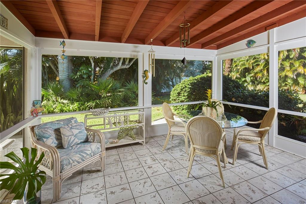 1829 Mandarin Road Naples, FL 34102 - Photo 1 of 14 a balcony with furniture and a potted plant