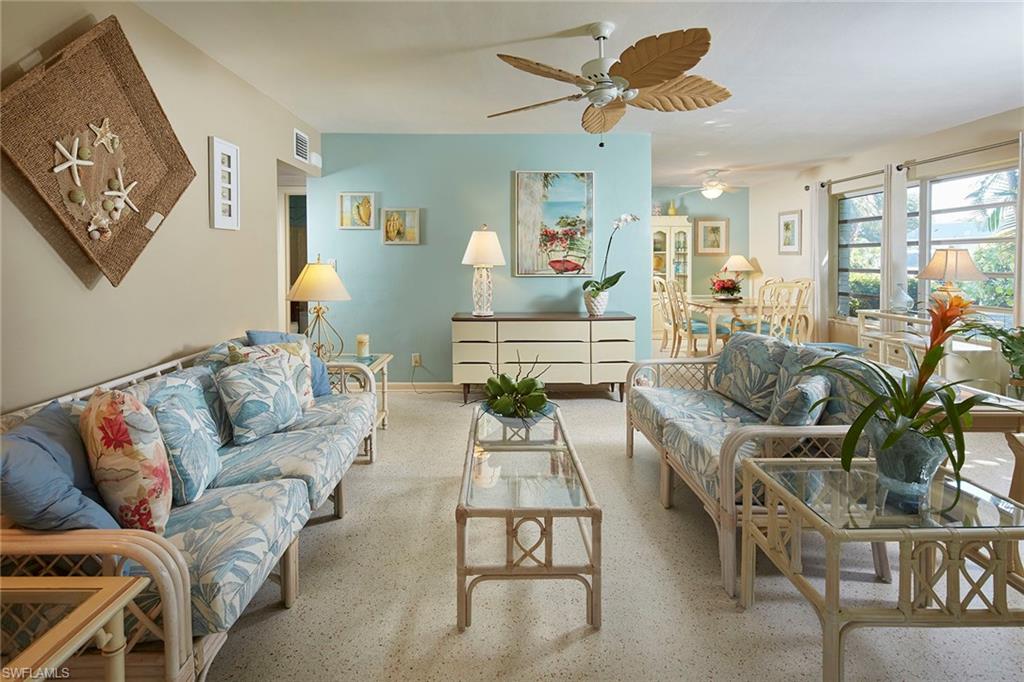 1829 Mandarin Road Naples, FL 34102 - Photo 3 of 14 a living room with furniture ceiling fan and a rug