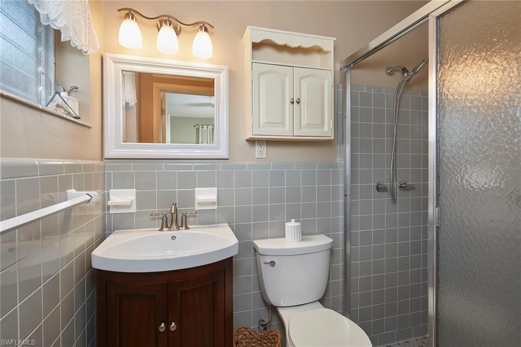 1829 Mandarin Road Naples, FL 34102 - Photo 8 of 14 a bathroom with a sink toilet and shower