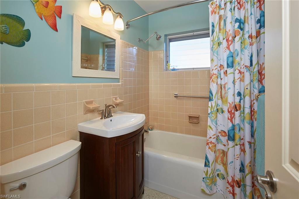 1829 Mandarin Road Naples, FL 34102 - Photo 10 of 14 a bathroom with a sink toilet and bathtub