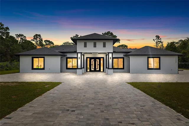 a view of a house with a yard and front view of a house