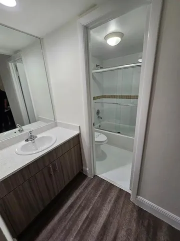 a bathroom with a sink a toilet and mirror