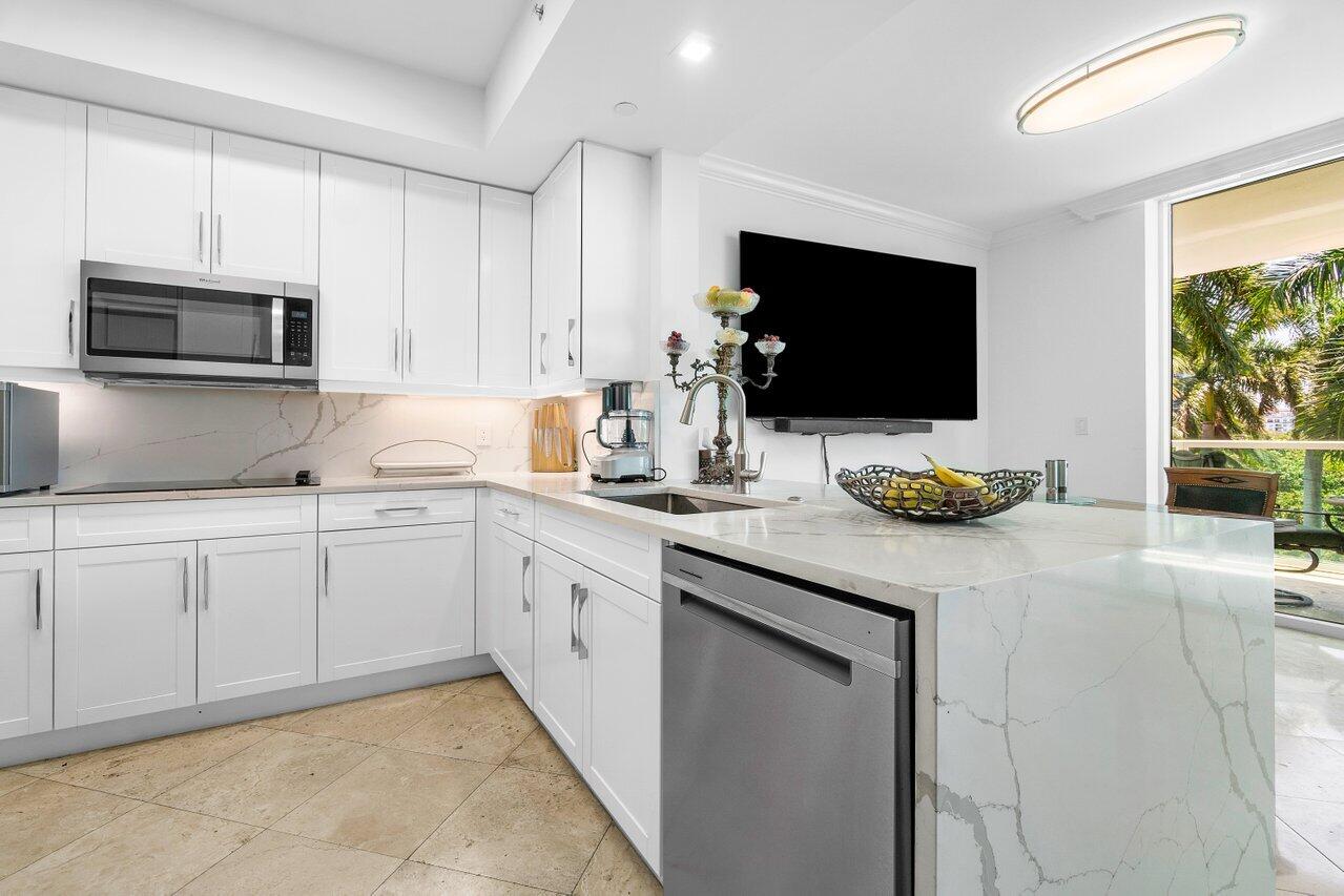 a kitchen with stainless steel appliances granite countertop a sink and a stove top oven
