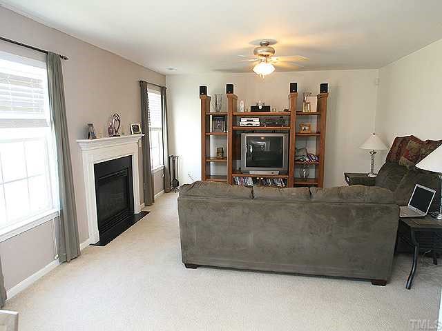 4102 Springfield Creek Drive Raleigh, NC 27616 - Photo 3 of 10 a living room with furniture and a fireplace