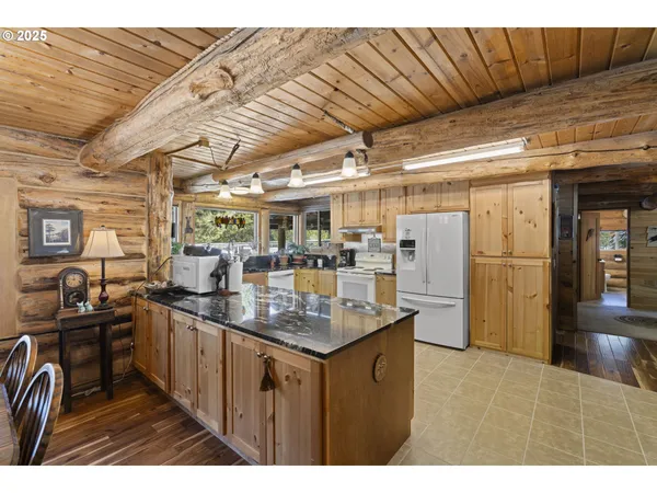 a kitchen with stainless steel appliances granite countertop a sink and cabinets