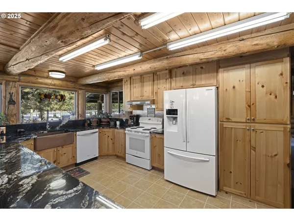 a kitchen with refrigerator and cabinets