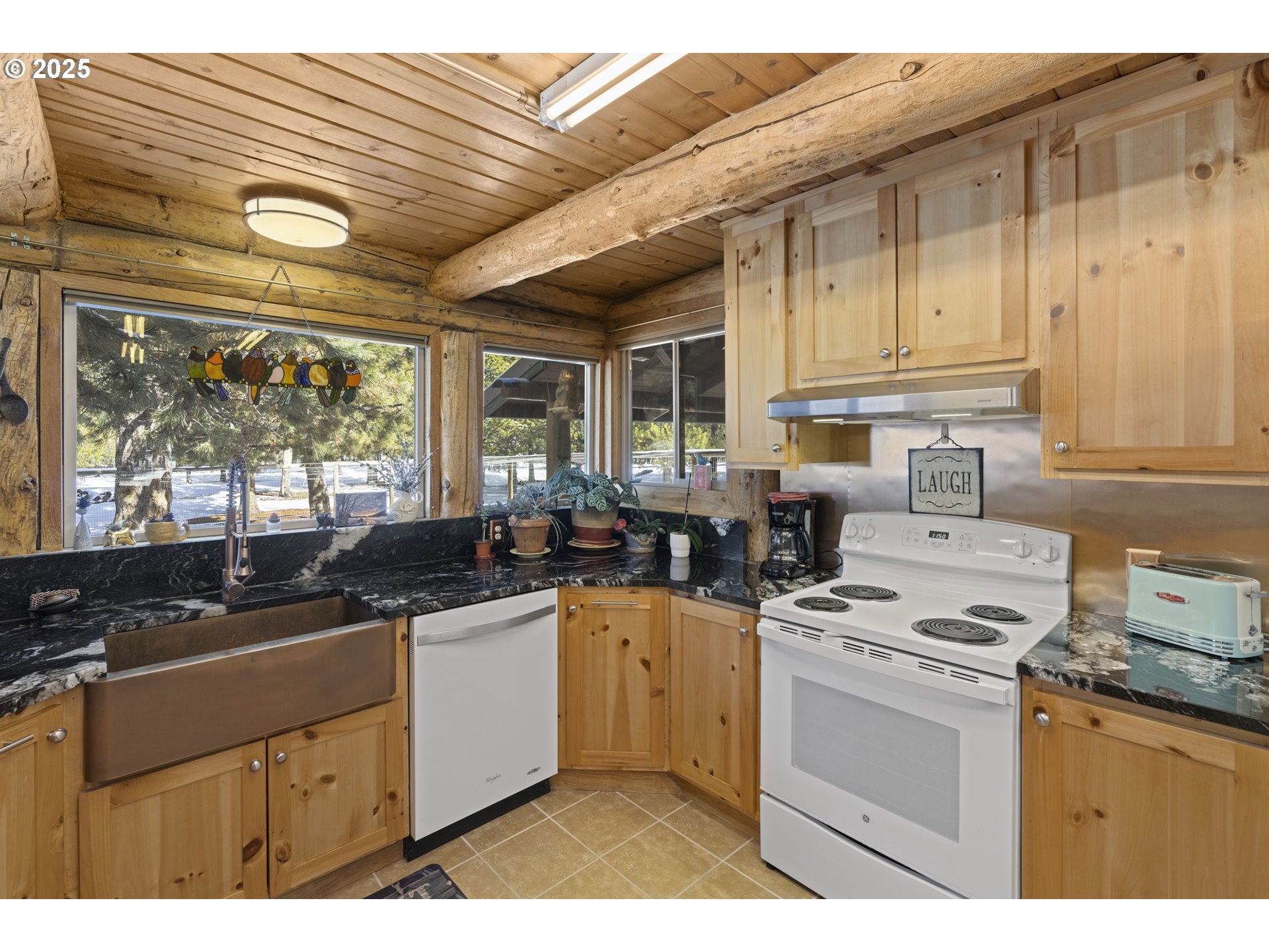 140643 Kamloop Lane Gilchrist, OR 97737 - Photo 15 of 36 a kitchen with a stove a sink and cabinets