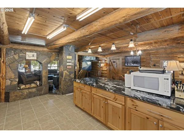 a kitchen with stainless steel appliances kitchen island granite countertop a sink and cabinets