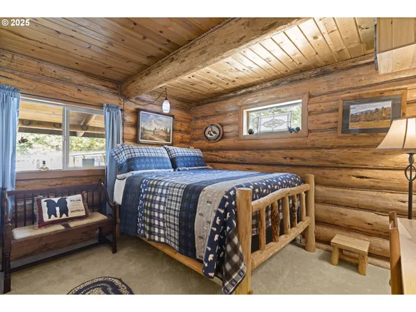 a bedroom with a bed next to a window