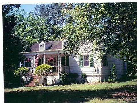 318 South King Charles Road Raleigh, NC 27610 - Photo 1 of 1 a front view of a house with a garden and trees