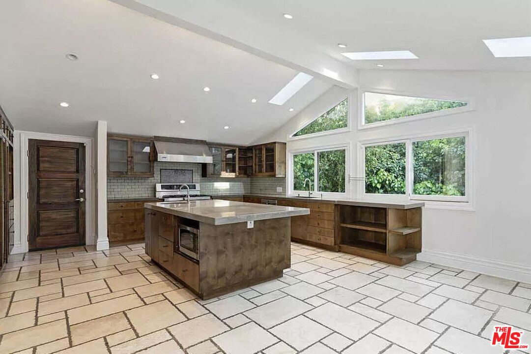 3441 White Rose Way Encino, CA 91436 - Photo 15 of 22 a large kitchen with stainless steel appliances granite countertop a stove and a sink