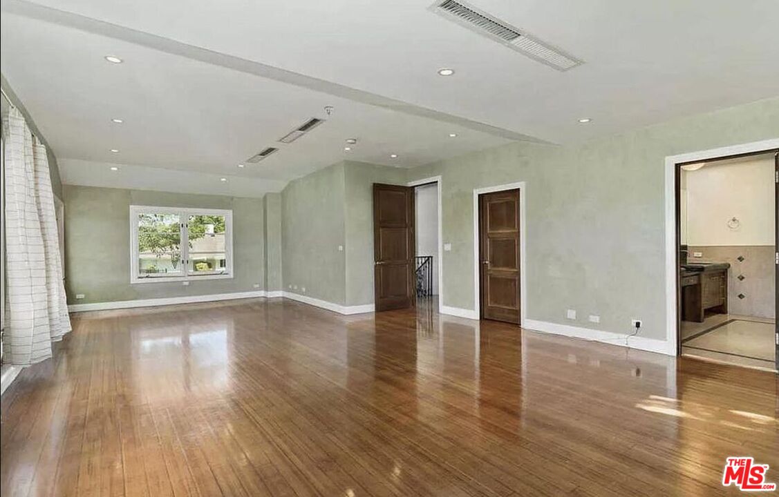 3441 White Rose Way Encino, CA 91436 - Photo 16 of 22 a view of an empty room with wooden floor and a window