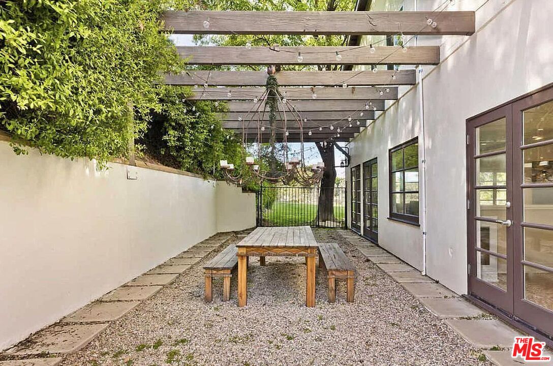 3441 White Rose Way Encino, CA 91436 - Photo 18 of 22 a view of a patio with table and chairs with wooden floor and plants