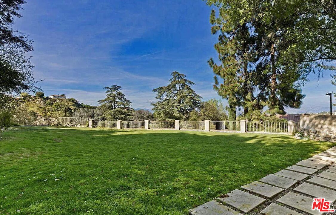 3441 White Rose Way Encino, CA 91436 - Photo 22 of 22 a view of grassy field with benches