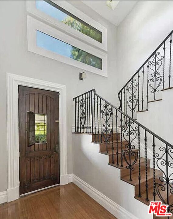 3441 White Rose Way Encino, CA 91436 - Photo 6 of 22 a view of staircase with lots of frames on wall and windows