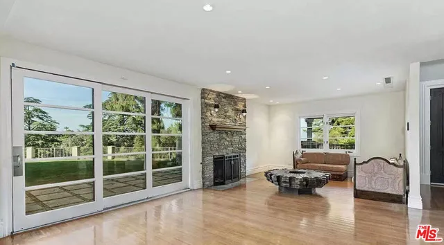 a living room with furniture window and wooden floor