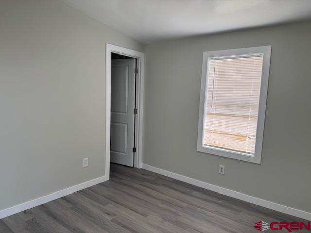 28260 Highway 160, Unit 81 Cortez, CO 81321 - Photo 12 of 20 an empty room with wooden floor and a window