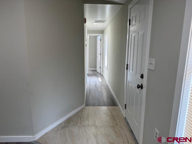 28260 Highway 160, Unit 81 Cortez, CO 81321 - Photo 15 of 20 a view of a hallway with wooden floor