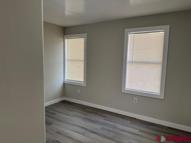 28260 Highway 160, Unit 81 Cortez, CO 81321 - Photo 16 of 20 a view of an empty room with wooden floor and a window